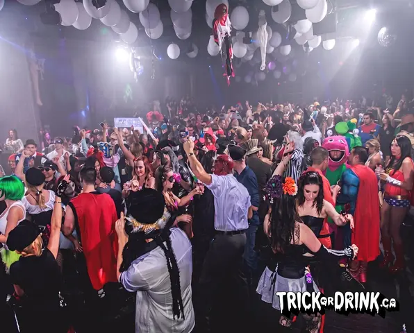 A packed Trick or Drink dance floor in costume, Toronto